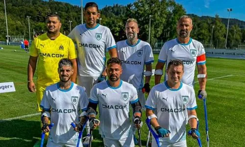 Les 7 joueurs de la section amputés de l’OM posent sur le terrain de foot.