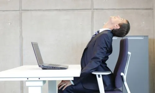 homme d'affaires faisant de l'exercice &agrave; son poste de travail