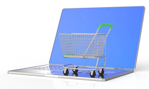 Un caddie de supermarché posé sur un écran d’ordinateur.