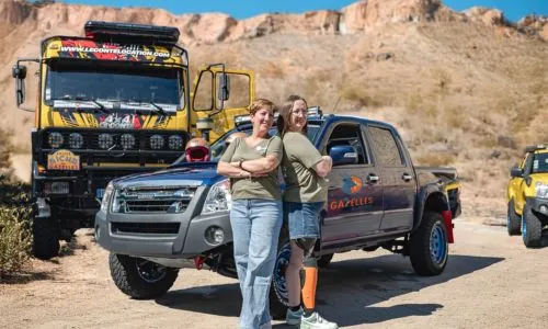 Alexandre et Ophélie posent devant leur 4x4 en plein désert.