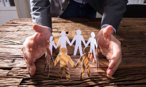 Deux mains qui entourent des bonhommes se tenant la main
